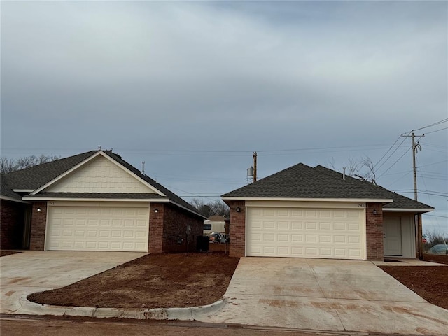 ranch-style house with an outbuilding, concrete driveway, brick siding, and a shingled roof