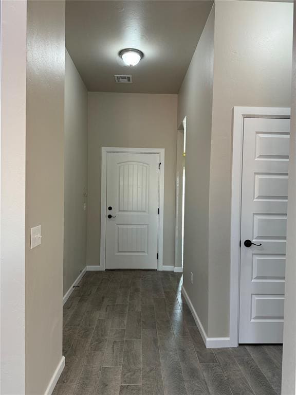 hallway featuring dark hardwood / wood-style flooring