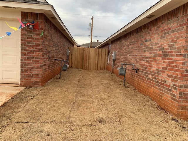 exterior space featuring a garage and fence