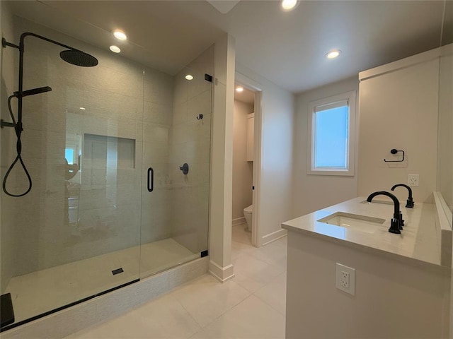 bathroom featuring tile patterned floors, vanity, toilet, and a shower with shower door