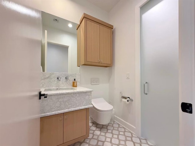 bathroom with vanity and toilet