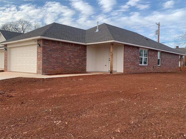 view of front of property with brick siding, driveway, an attached garage, and roof with shingles