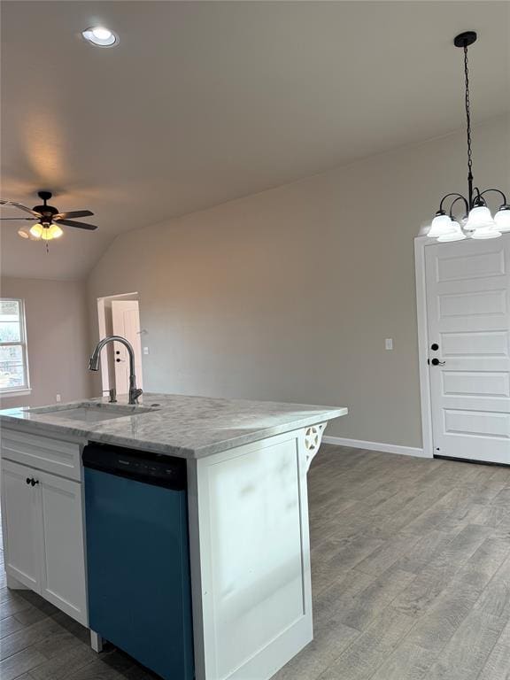 kitchen with pendant lighting, white cabinetry, dishwasher, sink, and an island with sink