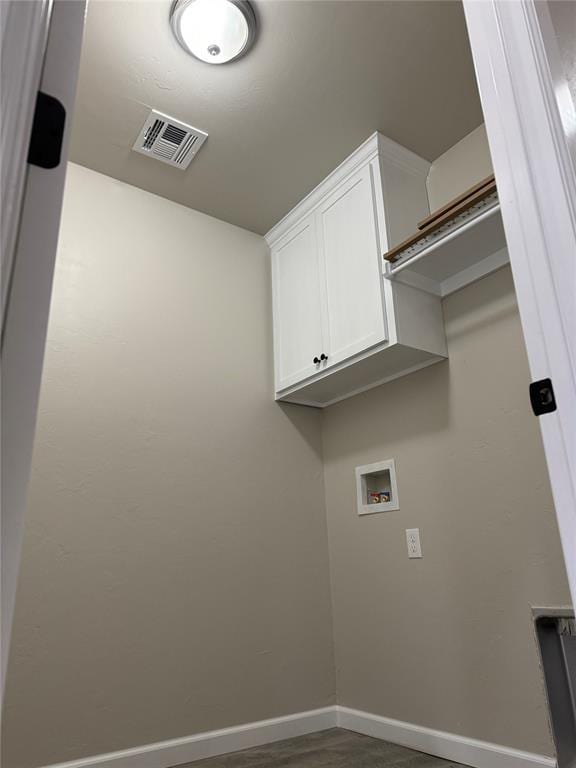 laundry room featuring hookup for a washing machine and cabinets