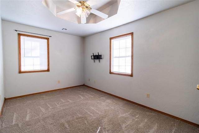 empty room with ceiling fan and carpet