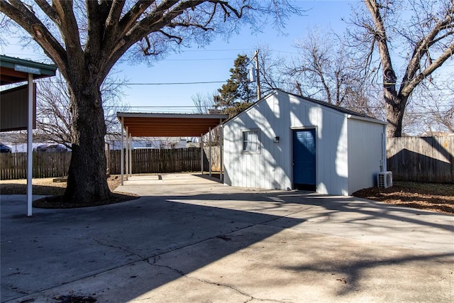 view of outdoor structure with a carport and central AC unit