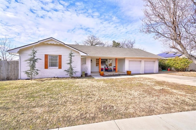 single story home with a garage, a front lawn, and a porch