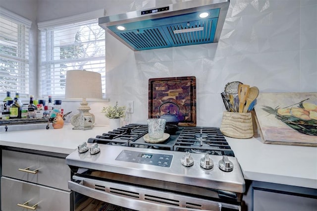 kitchen with stainless steel gas range oven and exhaust hood