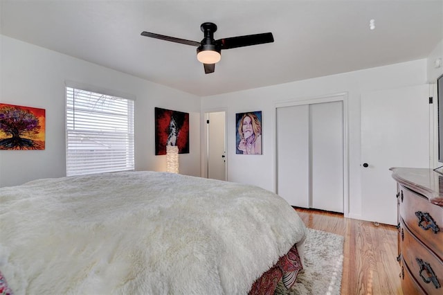 bedroom with light hardwood / wood-style flooring, a closet, and ceiling fan