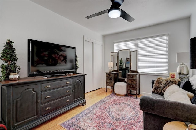 living room with ceiling fan and light hardwood / wood-style floors