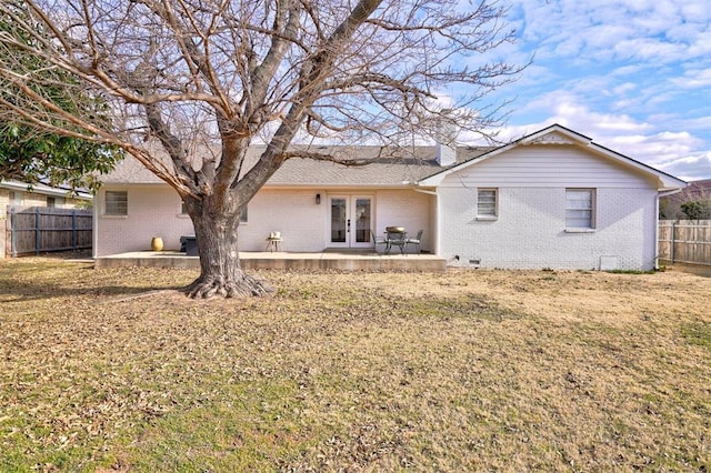 back of house with a patio, a yard, and french doors