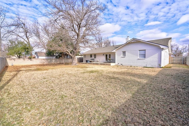 back of property featuring a lawn