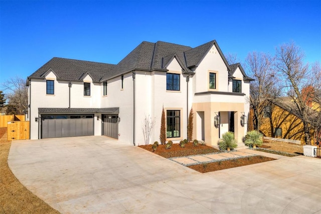 french country inspired facade featuring a garage