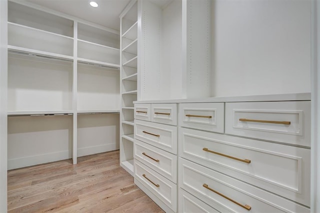 walk in closet featuring light hardwood / wood-style flooring