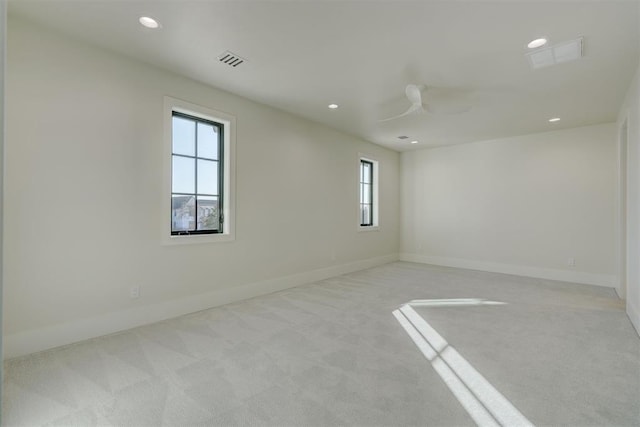 carpeted spare room with ceiling fan