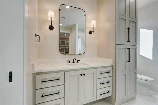 bathroom with vanity and toilet