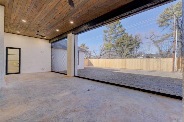 unfurnished sunroom featuring wooden ceiling and ceiling fan