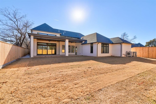 rear view of house featuring central AC unit