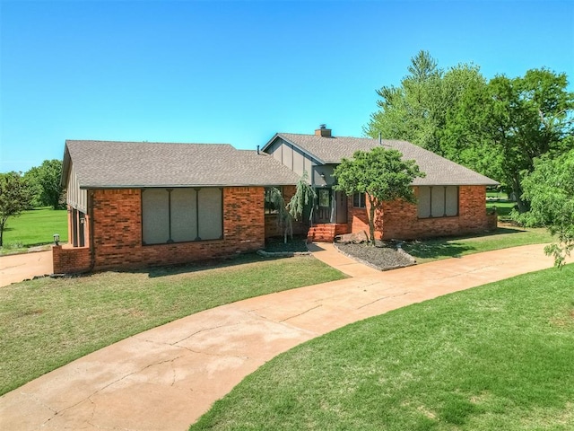 single story home featuring brick siding, a shingled roof, and a front yard