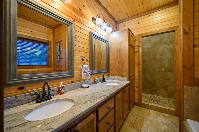 bathroom featuring tiled shower, vanity, wooden walls, and wooden ceiling