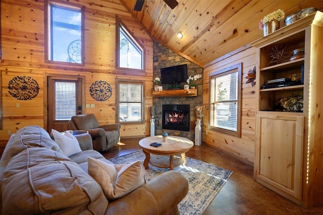 living room with wood ceiling, a fireplace, high vaulted ceiling, and wood walls