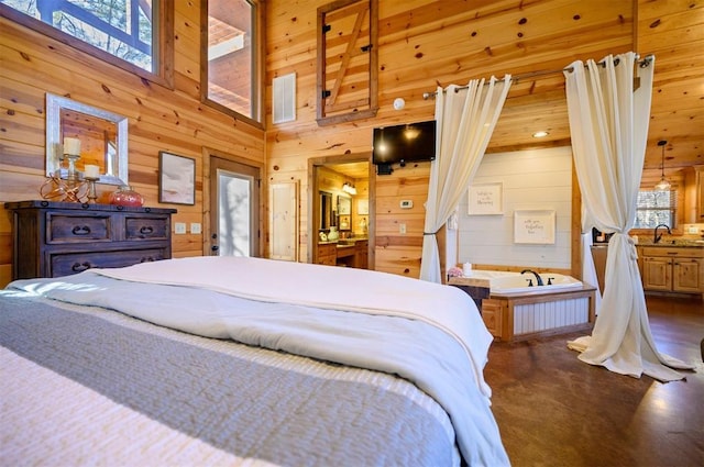 bedroom featuring a high ceiling and wood walls