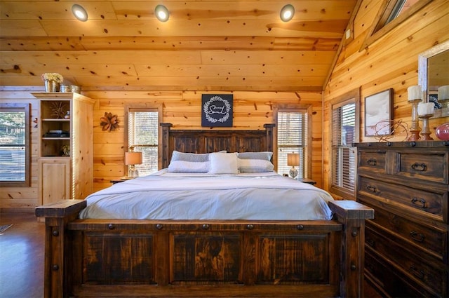 bedroom featuring multiple windows, vaulted ceiling, and wooden walls