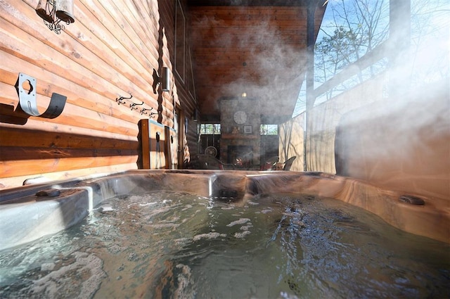 room details featuring a fireplace and wooden walls