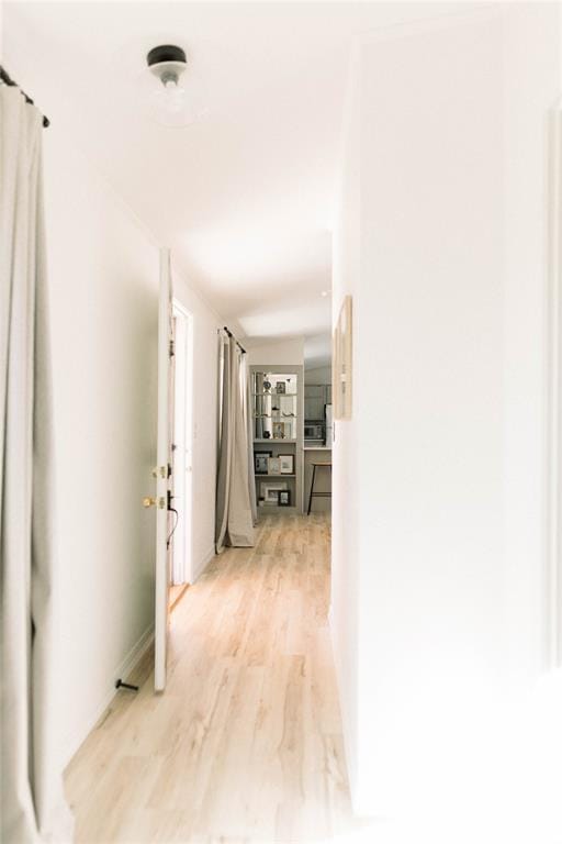 corridor with light wood-type flooring