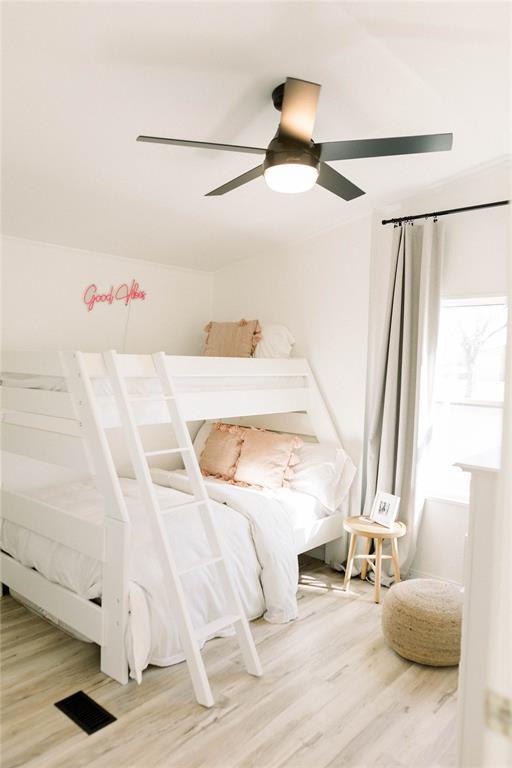 bedroom featuring wood-type flooring and ceiling fan