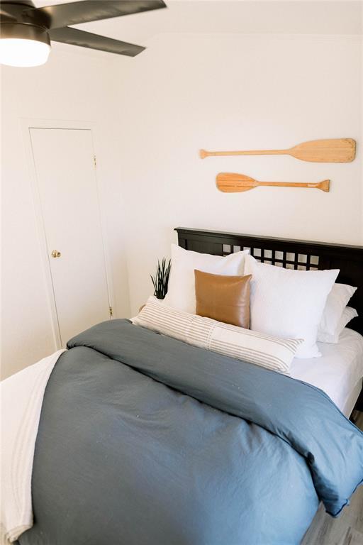 bedroom featuring wood-type flooring and ceiling fan