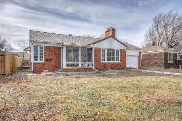 view of front of house with a garage and a front lawn