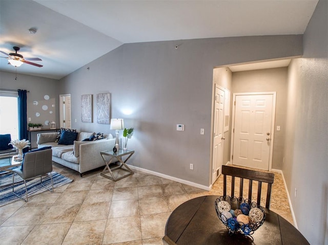 tiled living room featuring ceiling fan and lofted ceiling