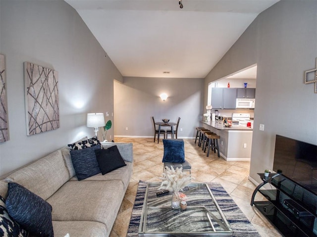 living room with vaulted ceiling and light tile patterned floors