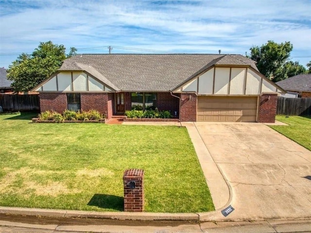 tudor house featuring a garage and a front yard