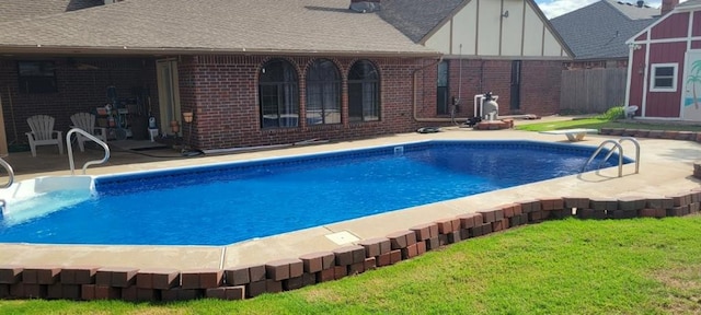 view of pool featuring a patio area and a lawn