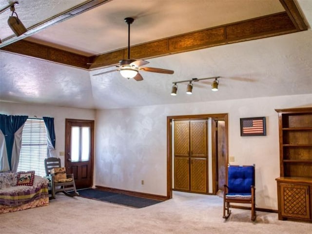 sitting room with carpet floors, ceiling fan, and vaulted ceiling