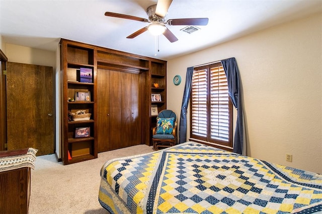 bedroom with carpet flooring, visible vents, a closet, and ceiling fan