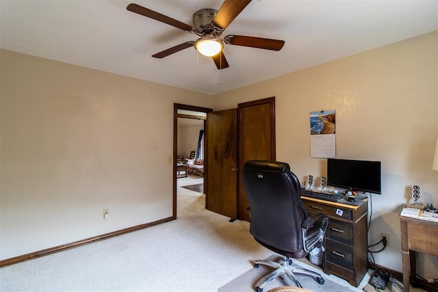 office with baseboards, light colored carpet, and ceiling fan