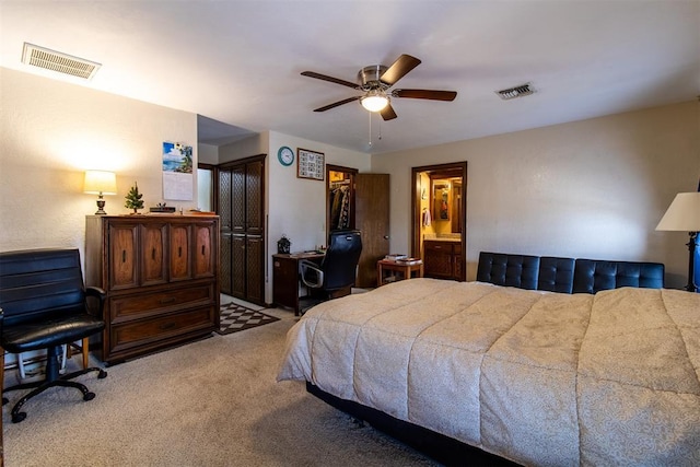 bedroom with visible vents, light colored carpet, and a ceiling fan