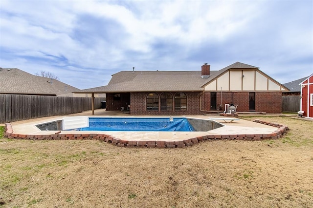 view of swimming pool featuring a diving board, a patio area, a fenced in pool, and a fenced backyard