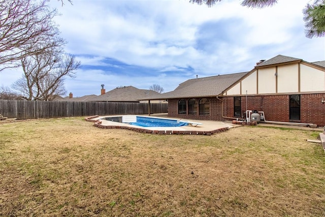 view of pool with a patio area, a lawn, and a fenced backyard