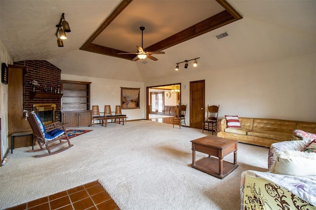 carpeted living room featuring visible vents, a brick fireplace, ceiling fan, lofted ceiling, and a raised ceiling