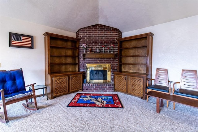 sitting room featuring a brick fireplace, a textured ceiling, lofted ceiling, and carpet floors