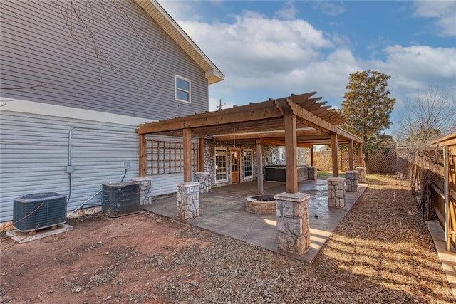 view of patio / terrace with a pergola, cooling unit, and an outdoor fire pit