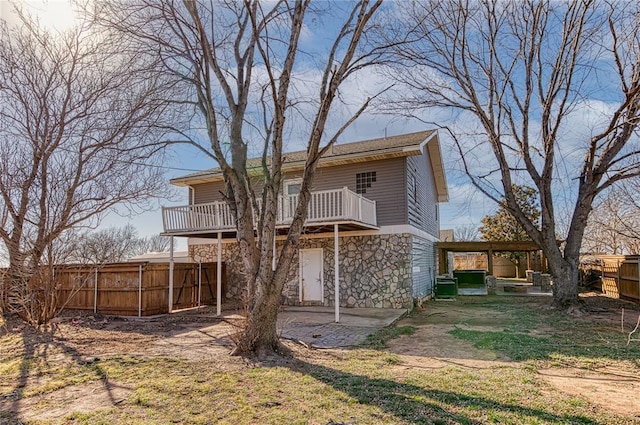 rear view of property featuring central AC unit and a deck