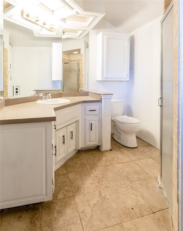 bathroom featuring vanity, coffered ceiling, toilet, and a shower with shower door