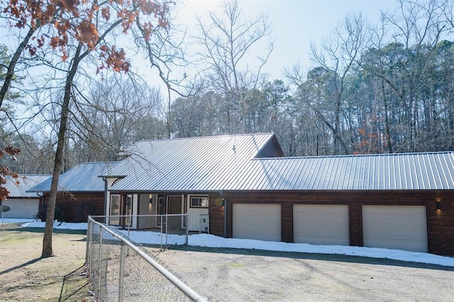 view of front of house with metal roof and a garage