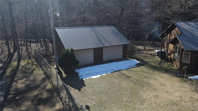 garage featuring a yard and central AC unit