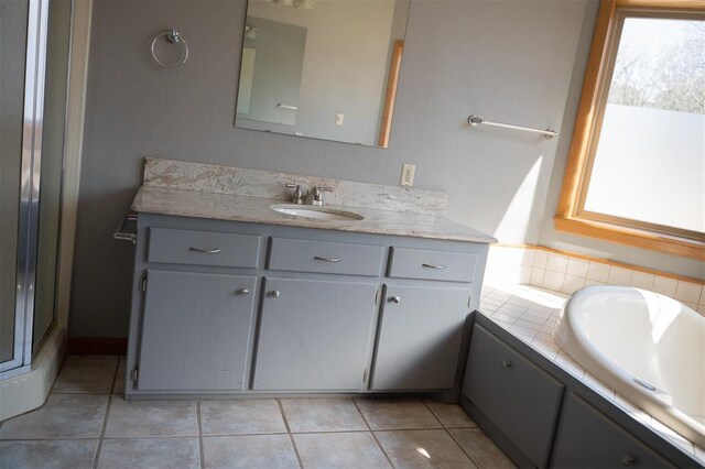 bathroom with tile patterned flooring, vanity, and a shower with door